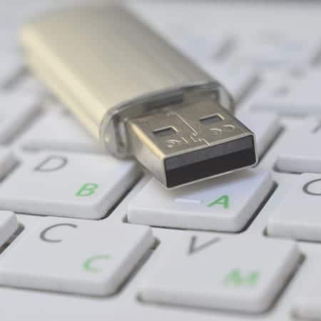 thumb drive on computer keyboard