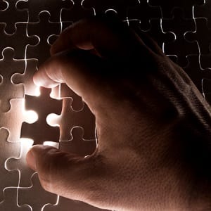 hand placing puzzle piece