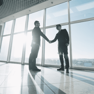 Men shaking hands during a business sale transaction